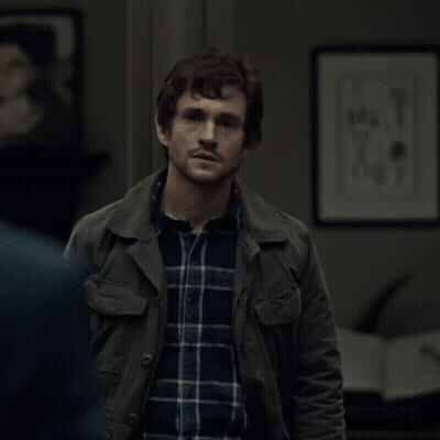 A Man Wearing A Plaid Shirt And A Green Jacket GIF