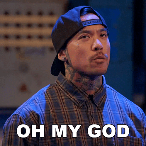 A Man Wearing A Plaid Shirt And A Hat Says " Oh My God " GIF