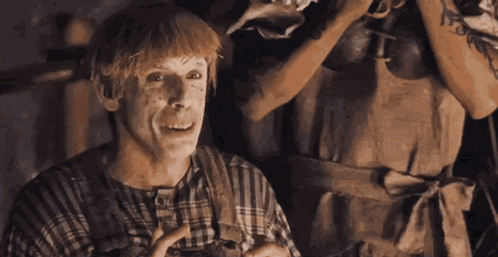 A Man Wearing A Plaid Shirt And Apron Is Laughing GIF