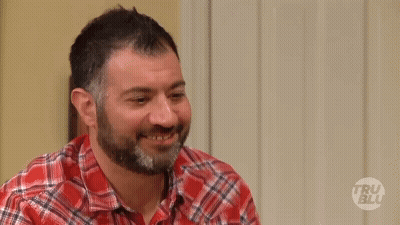 A Man Wearing A Plaid Shirt Is Asking Who Are You GIF