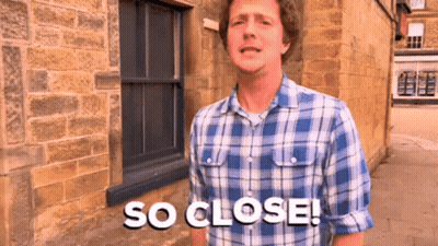 A Man Wearing A Plaid Shirt Says So Close GIF