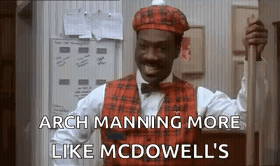 A Man Wearing A Plaid Vest And Hat Is Holding A Cane . GIF
