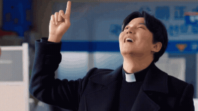A Man Wearing A Priest Collar Points Upwards With His Finger GIF