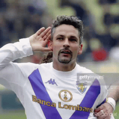A Man Wearing A Purple And White Jersey That Says Banca Lombard GIF