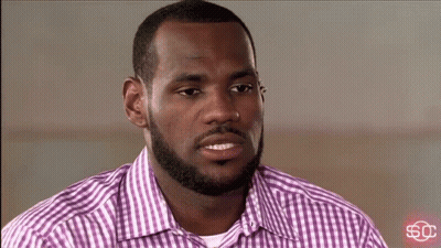 A Man Wearing A Purple And White Plaid Shirt With A Sc Logo In The Corner GIF