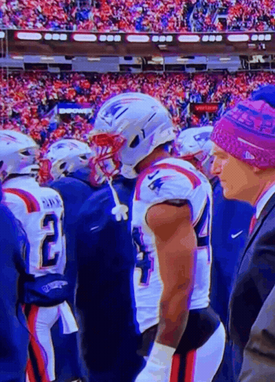 A Man Wearing A Purple Hat Is Standing Next To A Football Player Wearing A Patriots Jersey GIF