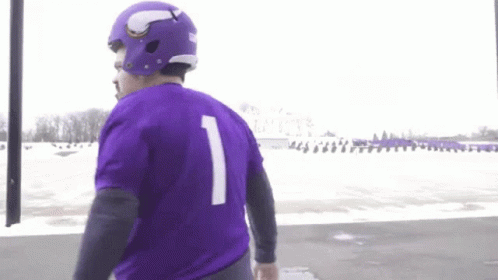A Man Wearing A Purple Jersey With The Number One On It GIF