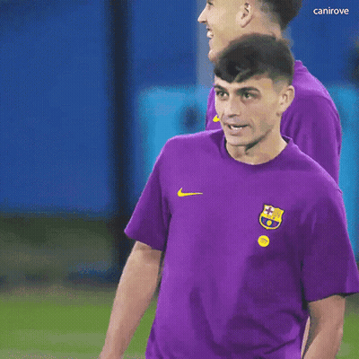 A Man Wearing A Purple Shirt With A Nike Logo On The Front GIF