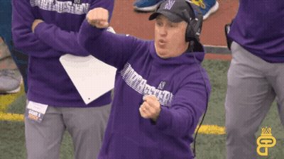 A Man Wearing A Purple Sweatshirt With The Letter N On It GIF