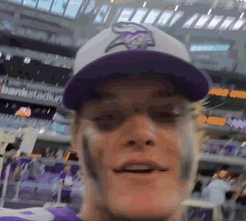 A Man Wearing A Purple Vikings Hat And A Purple Jersey GIF