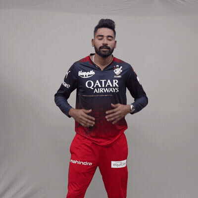 A Man Wearing A Qatar Airways Shirt Holds His Hands To His Chest GIF