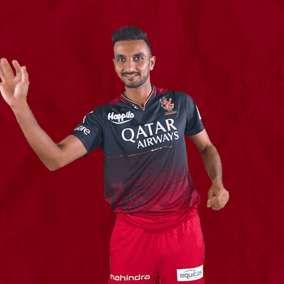 A Man Wearing A Qatar Airways Shirt Is Waving His Hand GIF