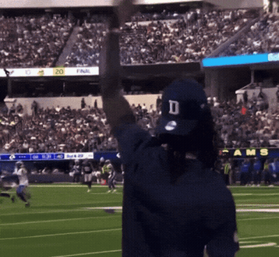 A Man Wearing A Rams Hat Stands On A Football Field GIF