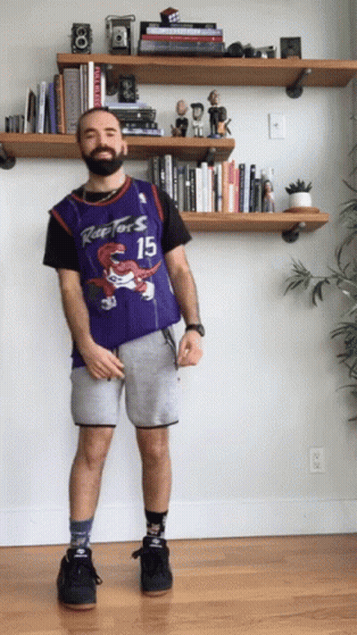 A Man Wearing A Raptors Jersey And Shorts GIF