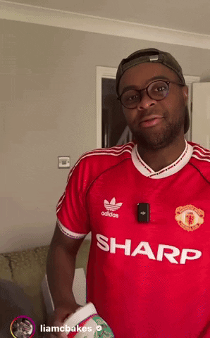 A Man Wearing A Red Adidas Shirt With Sharp Written On The Front GIF