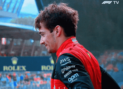 A Man Wearing A Red And Black Jacket With Aws On The Sleeve GIF