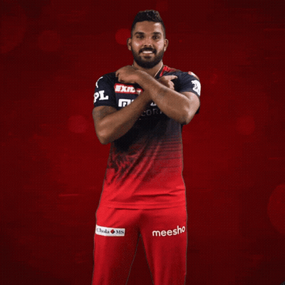 A Man Wearing A Red And Black Shirt That Says Exide Muthoot Fincorp On It GIF