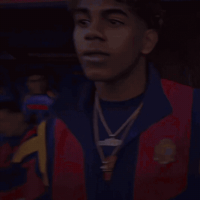 A Man Wearing A Red And Blue Jacket With A Gold Necklace Around His Neck GIF