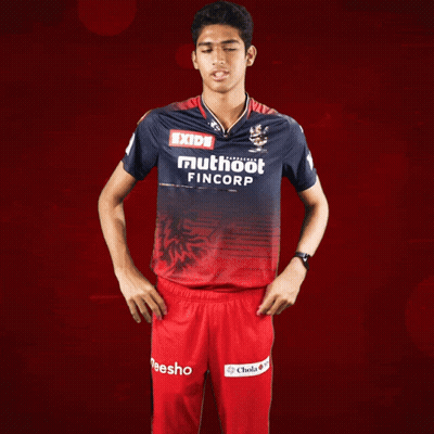 A Man Wearing A Red And Blue Shirt That Says Exide Muthoot Fincorp GIF