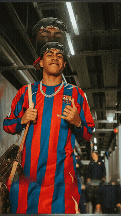 A Man Wearing A Red And Blue Striped Shirt With A Fcb Logo On It GIF