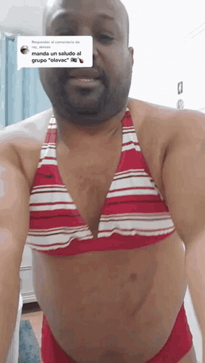 A Man Wearing A Red And White Bikini Top GIF