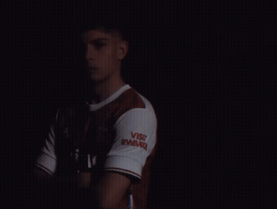 A Man Wearing A Red And White Emirates Shirt GIF