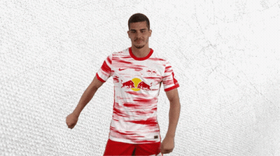 A Man Wearing A Red And White Jersey With A Bull On It GIF