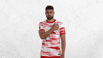 A Man Wearing A Red And White Jersey With A Red Bull On The Front GIF