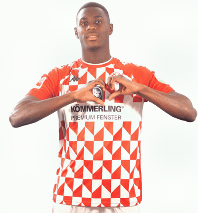 A Man Wearing A Red And White Shirt That Says Kommerling Premium Fenster Makes A Heart With His Hands GIF