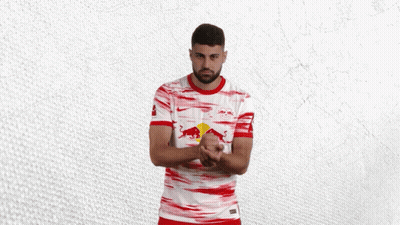 A Man Wearing A Red And White Shirt With A Bull On It GIF