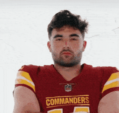 A Man Wearing A Red And Yellow Commanders Jersey GIF