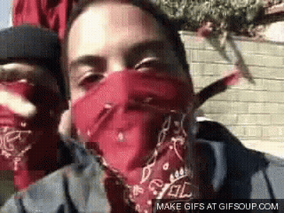 A Man Wearing A Red Bandana Covering His Face Is Smoking A Cigarette . GIF