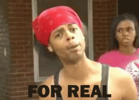A Man Wearing A Red Bandana Has The Words For Real Written On His Chest GIF