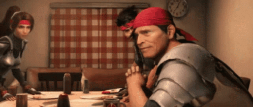 A Man Wearing A Red Bandana Sits At A Table With A Clock On The Wall GIF