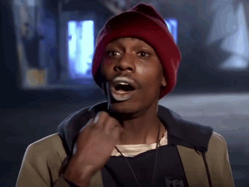A Man Wearing A Red Beanie And A Jacket With A Few Letters On It GIF