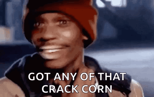 A Man Wearing A Red Beanie Is Smiling And Says `` Got Any Of That Crack Corn '' . GIF