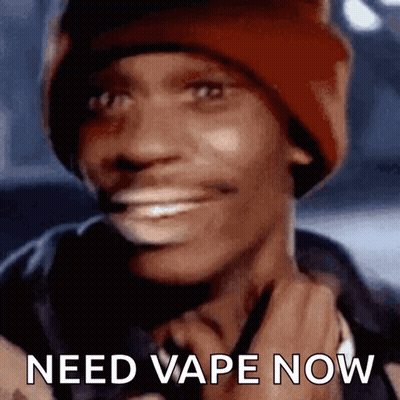 A Man Wearing A Red Beanie Is Smiling With The Words Need Vape Now Below Him GIF