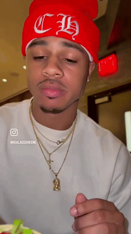 A Man Wearing A Red Beanie With Ch Embroidered On It GIF