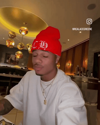 A Man Wearing A Red Beanie With The Letter Ch On It GIF