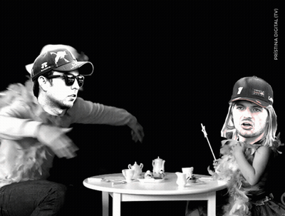 A Man Wearing A Red Bull Hat Sits At A Table GIF
