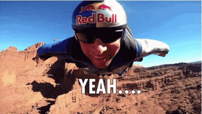 A Man Wearing A Red Bull Helmet And Sunglasses Is Flying Through The Air GIF