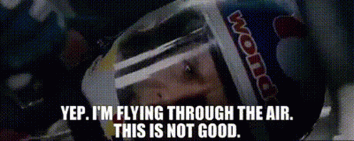 A Man Wearing A Red Bull Helmet Is Flying Through The Air . GIF