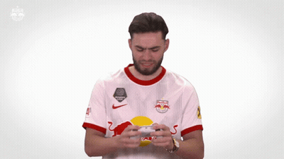 A Man Wearing A Red Bull Jersey Is Clapping GIF