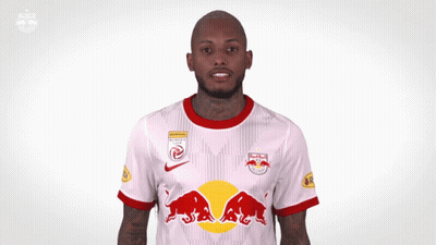 A Man Wearing A Red Bull Jersey Is Making A Funny Face GIF