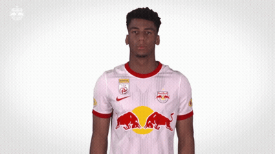 A Man Wearing A Red Bull Shirt Is Screaming GIF
