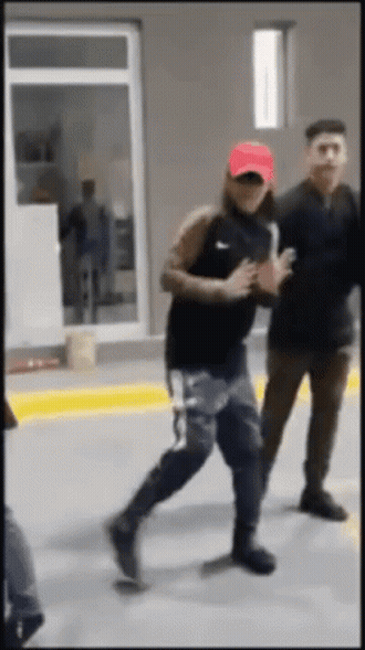 A Man Wearing A Red Hat And A Black Nike Shirt Is Running GIF
