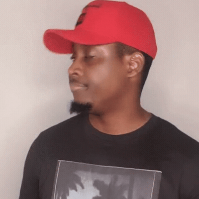 A Man Wearing A Red Hat And A Black Shirt With A Picture Of Palm Trees GIF
