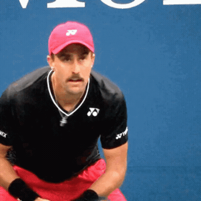 A Man Wearing A Red Hat And A Black Shirt With Yonex Written On The Sleeves GIF