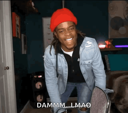 A Man Wearing A Red Hat And A Denim Jacket Says Dammm.lmao GIF