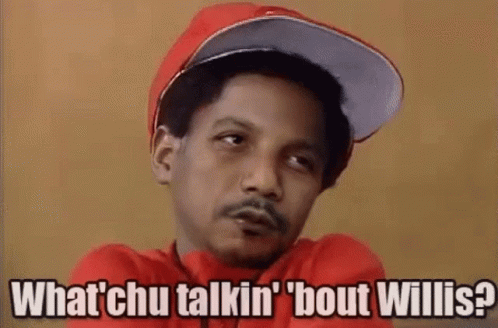 A Man Wearing A Red Hat And A Red Shirt Is Talking To Someone While Smoking A Cigarette . GIF